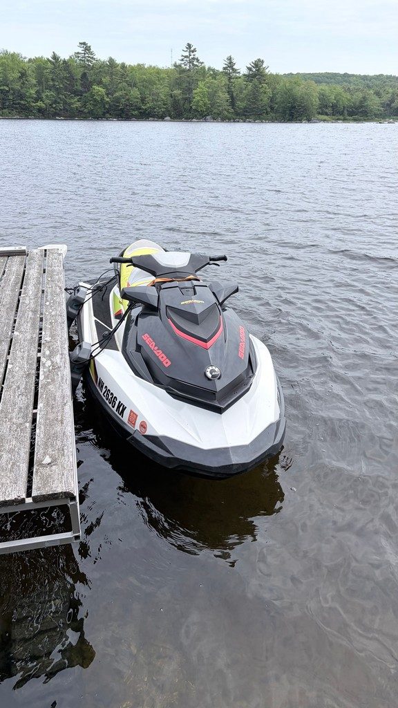 Sea-Doo jet ski secured bow-in at a New Hampshire lake dock