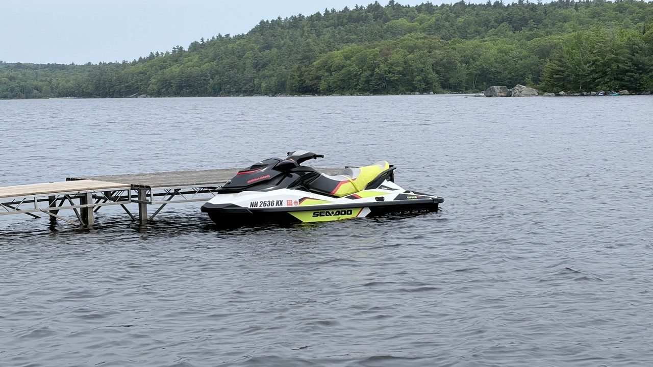 A Live Free Jet Ski Sea-Doo Wake 155 idling on a calm New Hampshire lake